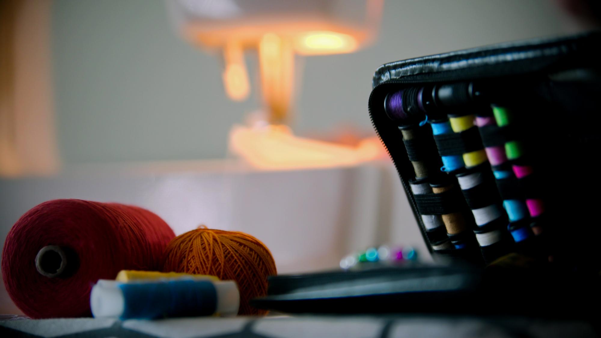 studio with sewing machine and neon threads